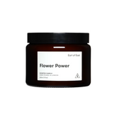 Brown candle jar with 'Flower Power' label on a light gray background