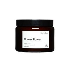 Brown candle jar with 'Flower Power' label on a light gray background